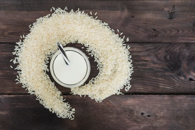 Free photo elevated view of rice milk and rice grains arranged over weathered background